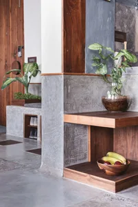 A modern entryway featuring concrete and walnut wood materials.