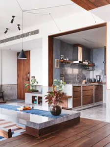 Contemporary residential kitchen featuring concrete countertops and wooden cabinets.