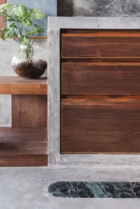 Modern living room featuring wood, concrete, and marble materials and design elements.