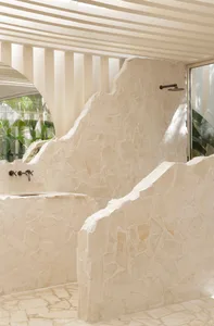 Minimalist bathroom featuring stone walls and flooring