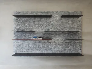 Black metal floating shelves mounted on a concrete textured wall