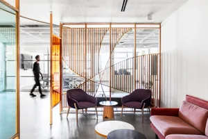 Industrial-style office break space featuring wood furniture and a modern, minimalist design.