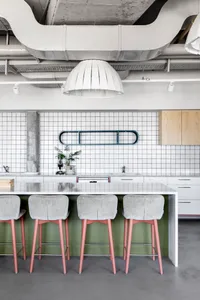 Modern coffee shop with industrial elements, concrete floor, cement tiles, and steel accents.