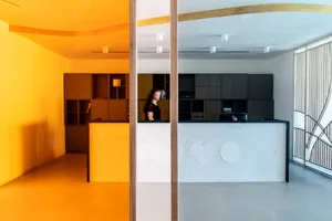 A modern reception desk with a concrete countertop and minimalist design.