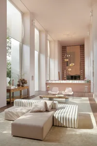 Modern minimalist living room featuring white materials and furniture.