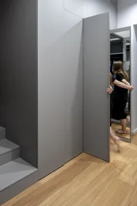 A modern, minimalist wardrobe with a wood laminate finish.