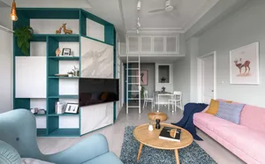 A modern living room featuring a blue and pink color scheme, with composite walls and a comfortable seating area, including a