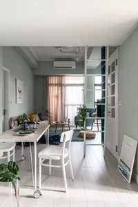 A modern living room featuring a minimalist design with neutral colors and clean lines.