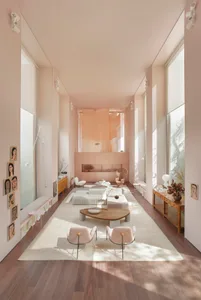 Modern minimalist living room with wooden furnishings and a large rug.