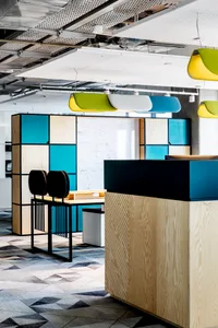A modern office space featuring a combination of materials and a colorful, geometric design