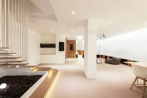 Modern residential interior with minimalist design, featuring natural wood flooring and clean lines.