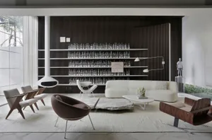 Modern living room with white and brown furniture, a white stone coffee table, and a black floor lamp on a white rug. The wal