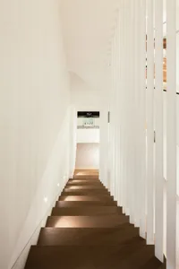Modern minimalist staircase with lighting in a contemporary interior design setting.