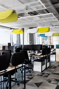 A modern office space with industrial design elements featuring metal, wood, and glass materials.