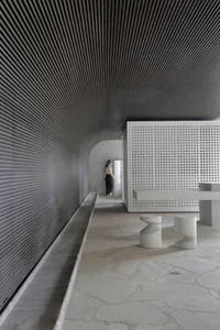 A minimalist interior design featuring concrete walls and flooring.