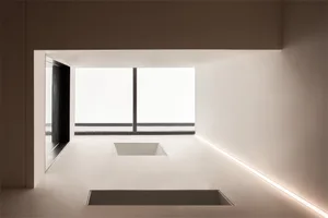Modern minimalist interior space with concrete walls and flooring.