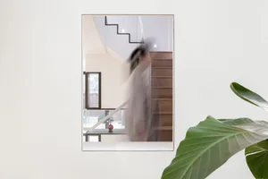 Glass mirror reflecting a staircase, capturing the play of light and shadows.