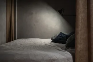Bedroom with minimalist design featuring a textured cotton blend bedspread on a single bed.