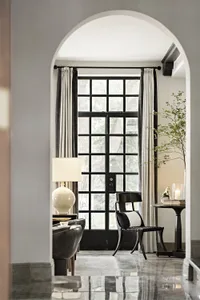 A modern interior featuring bold glass elements with a minimalist design and natural light.