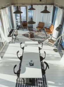 A modern industrial living room with marble flooring and mixed-media decorative accents.