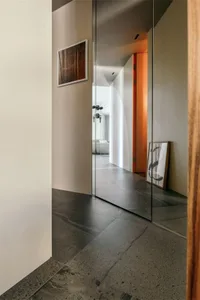 Modern interior design featuring metallic floor tiles and sleek lines.