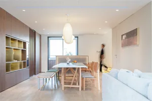 Modern residential space featuring wood, glass, and white materials.