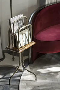 A metallic magazine stand featuring a sleek, modern design.