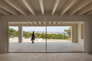 Interior design featuring concrete walls and floor, minimalist aesthetic.