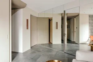 Modern minimalist interior with transparent glass walls and concrete flooring, showcasing sleek and sophisticated design elem