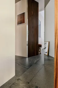 Modern entryway featuring dark wood and dark stone tile flooring