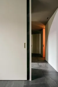 Modern hallway with concrete flooring and minimalist design.