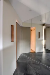 Modern interior design featuring glass walls and marble flooring.