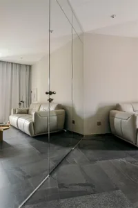 Modern living room featuring leather sofas, minimalist design, and sleek furniture.