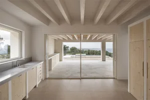Modern minimalist interior with concrete floor and wooden furniture