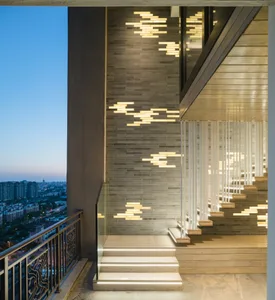Modern interior featuring illuminated staircase and glass balustrade.