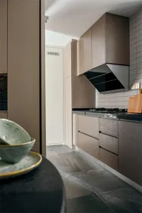 Modern kitchen featuring stone countertops and cabinets.