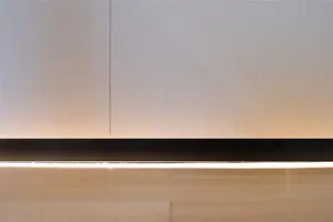 Close-up of a minimalist interior featuring a metal wall paneling.