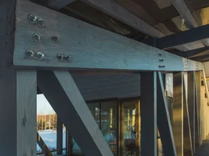 A close-up view of industrial-style steel beams with bolts, showcasing an exterior architectural detail.