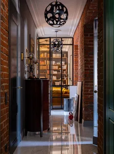 Industrially styled interior design featuring brick walls and polished marble floors.