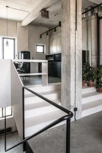 Industrial-style interior design featuring concrete material and minimalist design elements.
