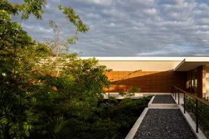 Modern building exterior featuring wooden materials and a spacious walkway.