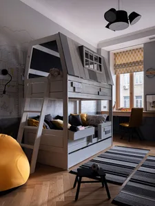 Modern children's bedroom featuring a bunk bed with a timber design, brightly colored textiles, and a yellow bean bag chair.