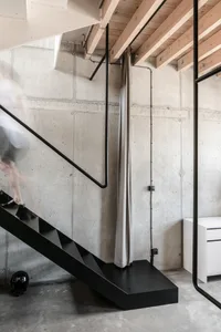 Modern industrial interior design featuring concrete walls and minimalist style.