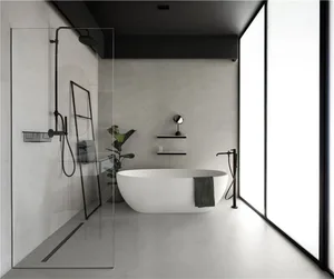 A modern minimalist bathroom featuring a freestanding bathtub, concrete walls, and a glass shower enclosure.