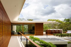 Modern residential exterior showcasing wooden accents and stone elements.