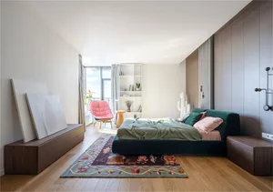 Minimalist bedroom with wooden furniture, carpet flooring, and fabric bedding.