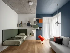 Minimalist child's bedroom with concrete, wood, and fabric materials.