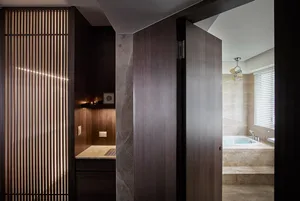 A modern bathroom featuring wood paneling and marble and metal elements.