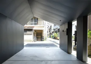 An urban entrance way featuring modern, minimalist architectural design elements.