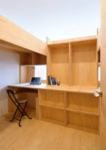 A modern home office with a wooden desk and chair.
